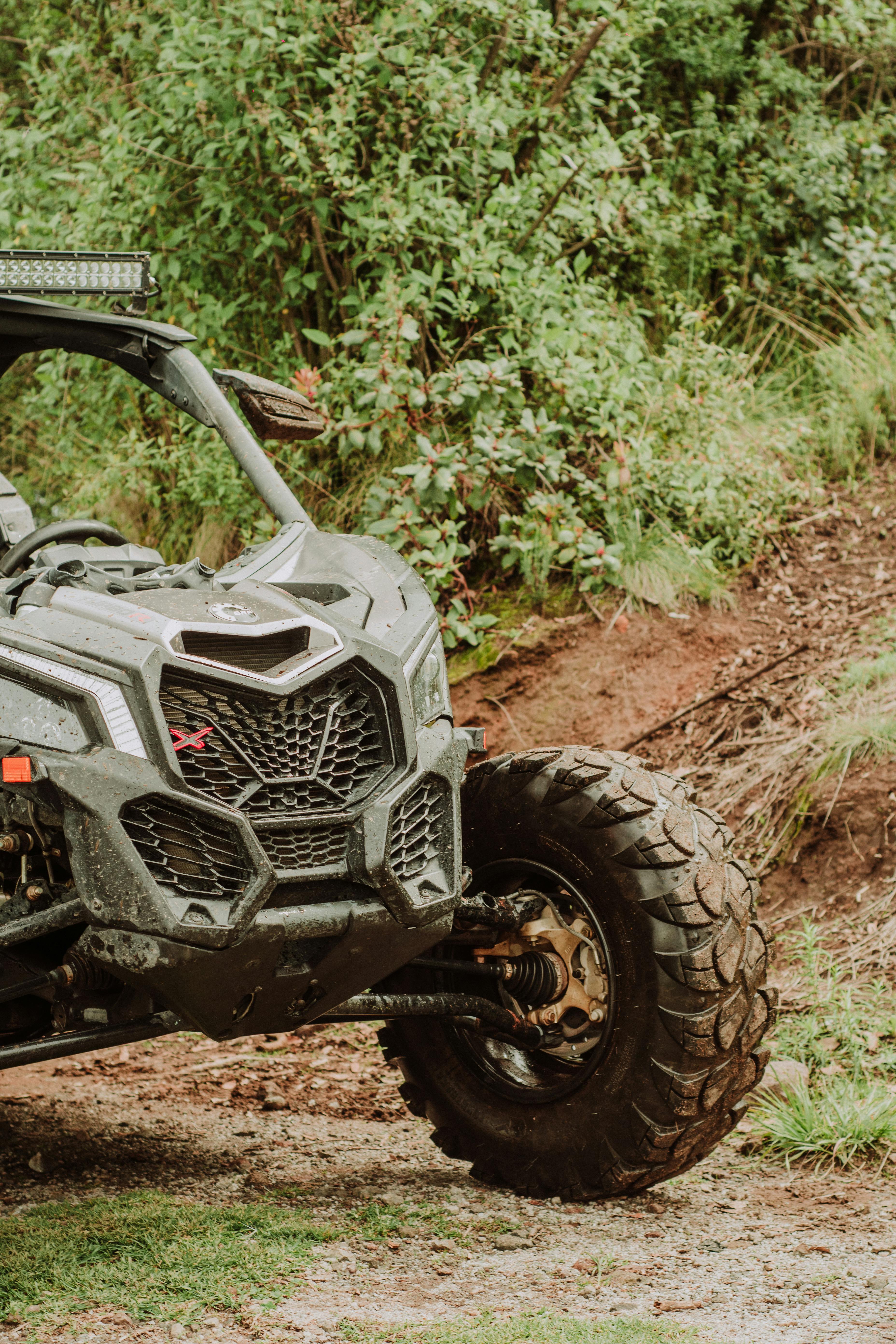An off-road vehicle navigating rugged mountain terrain in the summer