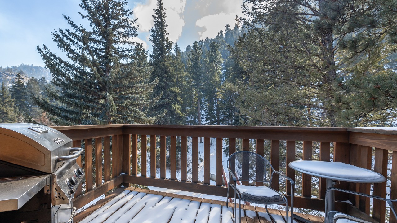 Private deck overlooking the Fall River in Estes Park, CO, for Riverview Suite guests
